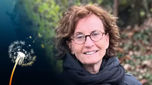 Ingrid Lomfors ler med glasögon och en scarf. En maskros sprider sina frön i bakgrunden.