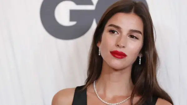 Sandra Gago, con labios rojos y joyas brillantes, posa ante un fondo con el logo de GQ.