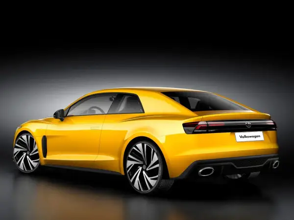 Żółty Volkswagen Corrado z nowoczesnym designem, sportowymi felgami i podwójnymi końcówkami wydechu.