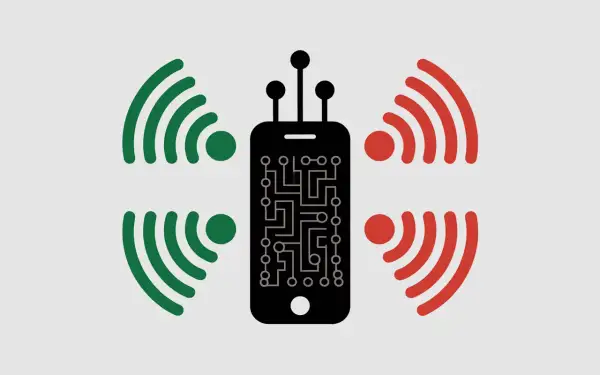 Smartphone noir avec circuit imprimé, entouré de signaux verts et rouges. L'iPhone 11 est-il 5G ou pas ?