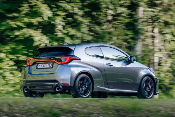 La Toyota Yaris GR scatta sull'asfalto, liberando i suoi cavalli in un turbine di verde.