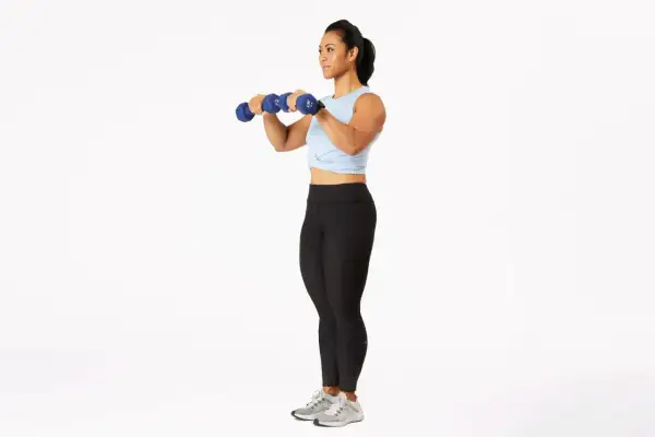 Woman performing dumbbell bicep curls, a key exercise for how to get stronger arms for a girl.