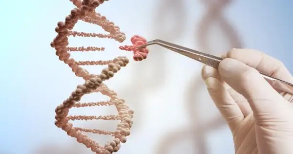 Ręka w rękawiczce trzyma pęsetą fragment DNA, jakby tworząc jego klon.