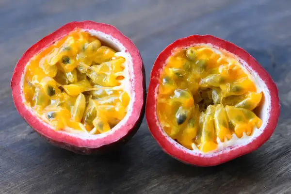 Fruit de la passion coupé en deux, révélant sa pulpe juteuse et ses graines. Un délice tropical, ce fruit est réputé pour être le fruit avec le plus de fibre.