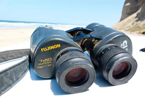 Binocolo Fujinon 7x50 FMTR-SX, con cinturino, pronto per esplorare le caratteristiche del paesaggio marino.