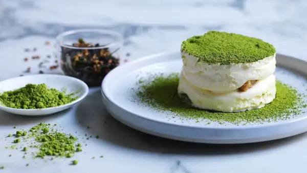 Dolci veloci al matcha: soffice crema e polvere verde brillante su un piatto, con ingredienti a lato.