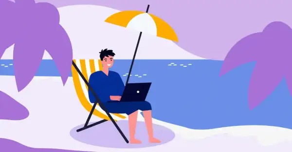 Mężczyzna pracuje na laptopie na plaży pod parasolem. Idealne miejsce na urlop, od kiedy 35 dni urlopu to norma.