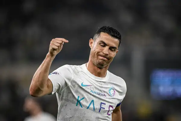 Cristiano Ronaldo z grymasem na twarzy, być może po kontuzji, unosi pięść.