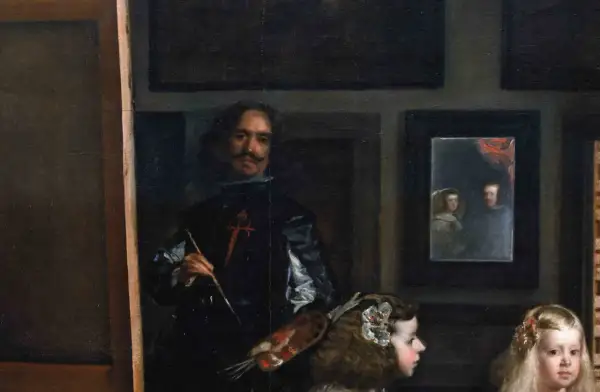 A painter, brush in hand, stands before a canvas, surrounded by royalty. This famous art from the Baroque period captures a moment of creation.