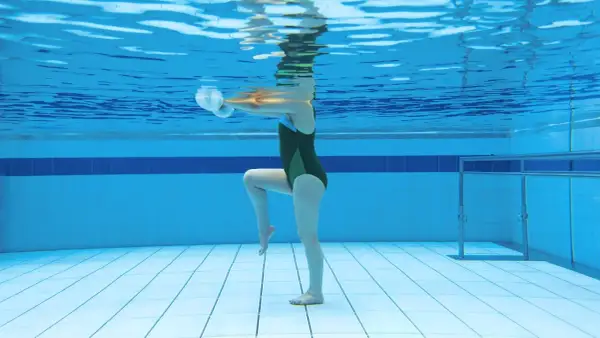 Underwater view of a person doing aquatic exercise with weights, showcasing the running in water benefits for a low-impact workout.