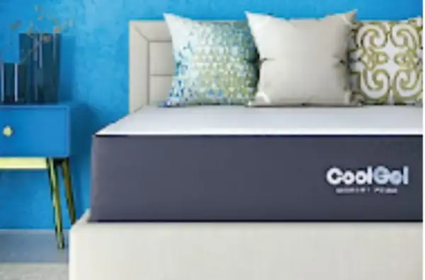 A CoolGel memory foam mattress on a bed with decorative pillows. Is memory foam safe? Yes, this mattress offers safe, comfortable sleep.