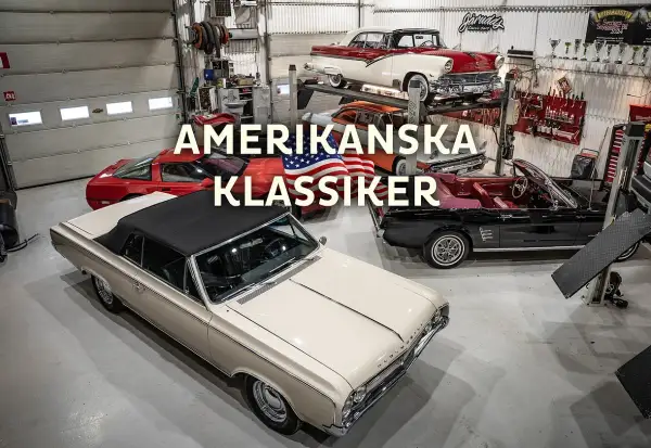 En samling amerikanska bilar, inklusive en beige cabriolet och en röd sportbil, står i ett garage.