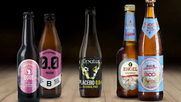 Cinque bottiglie di birra analcolica, tra cui una con etichetta "Doge IPA" e un'altra "Placebo 0,0%", perfette per chi cerca un'alternativa senza alcol, anche se non sono birra 10 gradi.
