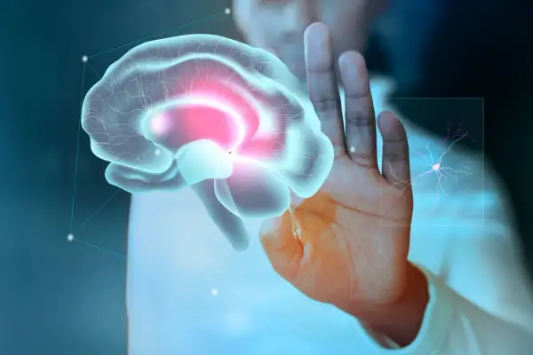 Dłoń dotyka wirtualnego mózgu, sugerując diagnostykę i zapalenie opon mózgowych leczenie. Obok neuron.