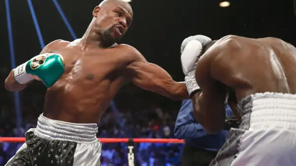 Boxer throws a punch, showcasing the intensity of most popular boxing weight classes.