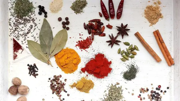 Variedad de especias: cúrcuma, pimentón, anís estrellado, canela, cardamomo, clavo, pimienta, bayas de enebro y más.