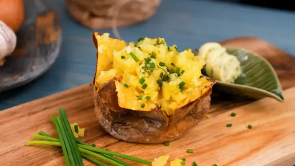 En fluffig, bakad potatis i micro, toppad med gräslök och serverad med örtsmör. Enkel och god middag!