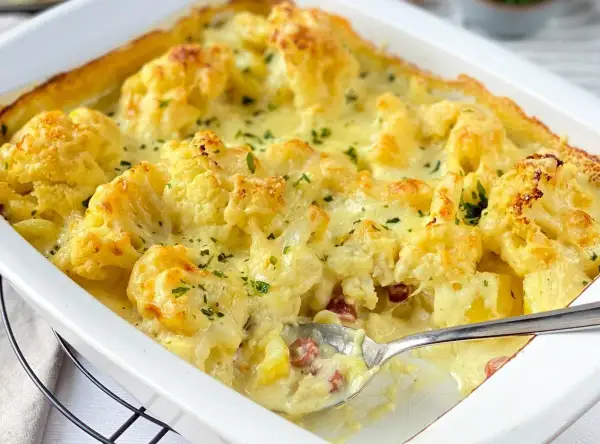 Ein cremiger Blumenkohl Kartoffel Auflauf mit Käse überbacken, garniert mit Petersilie. Perfekt für ein herzhaftes Abendessen.
