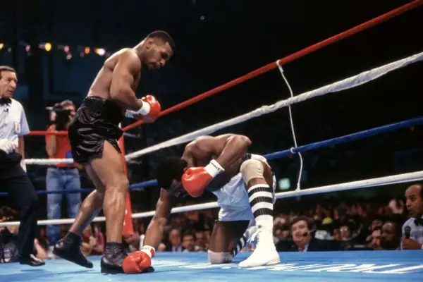 Mike Tyson lands a powerful punch, sending his opponent to the canvas. A classic example of the best Mike Tyson knockouts.