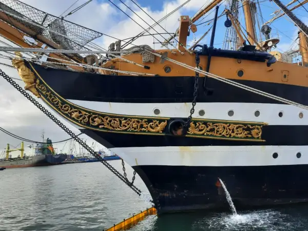 La prua ornata del veliero Amerigo Vespucci ad Ancona, con catene e decorazioni dorate.