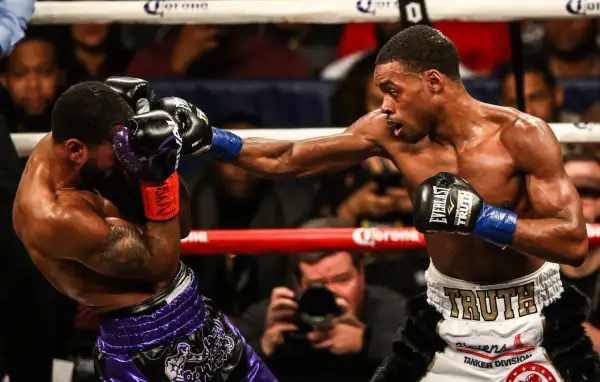 A boxer lands a powerful punch, while his opponent attempts to block with a jab. The intensity of the jab vs punch is palpable.
