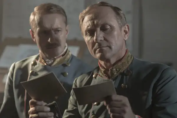 Dwóch mężczyzn w mundurach wojskowych analizuje dokumenty. Scena z filmu "Pacjentka", adaptacji książki.
