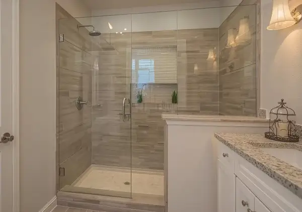 A modern bathroom featuring a spacious glass-enclosed shower with wood-look tile walls, a testament to a successful DIY shower tile installation.