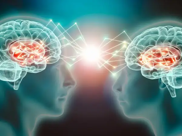Dwa mózgi połączone siecią neuronów, symbolizujące komunikację i wyrzut dopaminy.