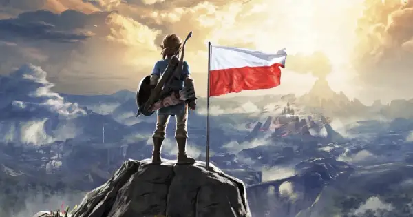 Link z tarczą i łukiem na szczycie góry, obok polska flaga. Widok na górzysty krajobraz z zamkiem w oddali. Zelda po polsku.
