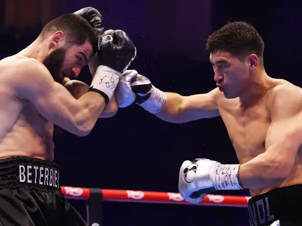 Two boxers clash in the ring. The boxer on the left, with "BET..." on his shorts, is in the light heavyweight beterbiev weight class.