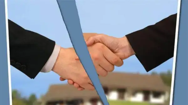 Mani che si stringono, ma una linea blu le divide. La psicologia del voltare le spalle a un accordo.