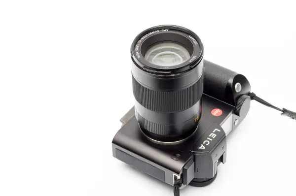 A black Leica camera with a Leica 75mm Summicron lens attached, ready to capture stunning portraits.