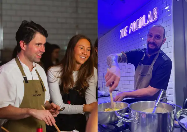 Två glada personer deltar i roliga kurser i matlagning. En man och en kvinna ler medan de lagar mat, och en kock med tatueringar rör i kastruller under neonskylten "THE FOODLAB".