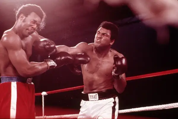 Two boxers in the ring, one landing a punch. The intensity of the fight suggests a close match, perhaps even a unanimous drawing.