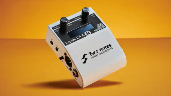 Two Notes Torpedo C.A.B. M, a white audio device with knobs and ports, offering free IR cabs for virtual cabinets.