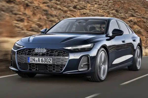 Eleganckie Audi A6 w ciemnym kolorze, jadące po drodze. Sprawdź atrakcyjną audi a6 cena i wybierz swój wymarzony model.