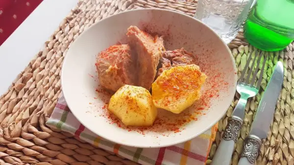 Un plato de carne o caldeiro con patatas, espolvoreado con pimentón.
