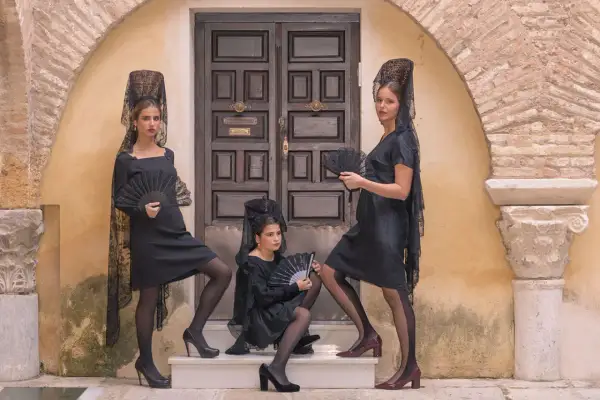Tres mujeres con mantillas y abanicos negros, listas para bailar. ¡we love flamenco!