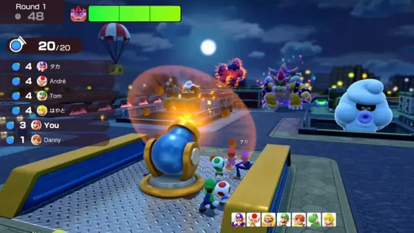 Postacie z Mario Party Jamboree w nocy, Bowser i Boo patrzą na armatę.