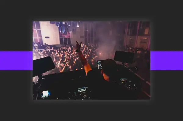 DJ playing to a cheering crowd, a scene that inspires anyone wondering how to get DJ gigs.