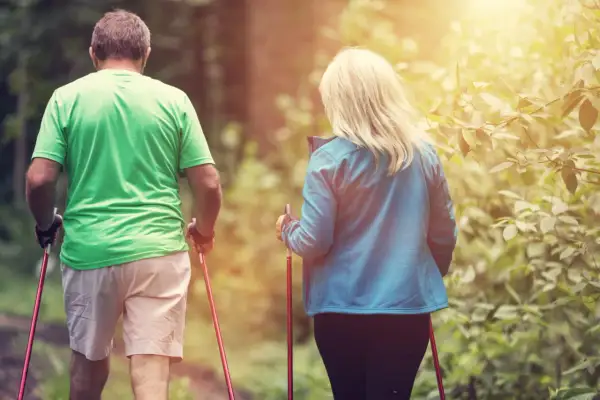 Couple en randonnée. Combien de pas par jour pour une femme de 65 ans ? L'activité physique est essentielle pour rester en forme.