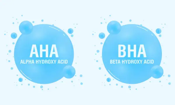 Dwa bąbelki z napisem AHA (Alpha Hydroxy Acid) i BHA (Beta Hydroxy Acid). Kwasy AHA jakie to? To składniki kosmetyków.