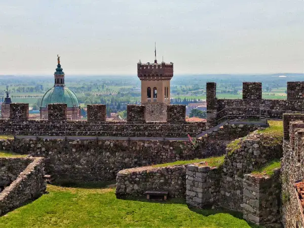 Rocche medievali a Lonato sul Garda, con una torre imponente e una cupola verde sullo sfondo.