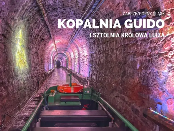 Podziemny spływ w kopalni Guido. Łódź płynie przez oświetlony tunel z kamiennymi ścianami.