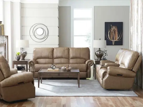 A cozy living room featuring a tan leather sofa and recliners, perfect for a Bassett Furniture identification and value guide.