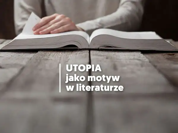 Otwarta księga na drewnianym stole, symbolizująca utopijny i realny obraz rzeczywistości w literaturze.