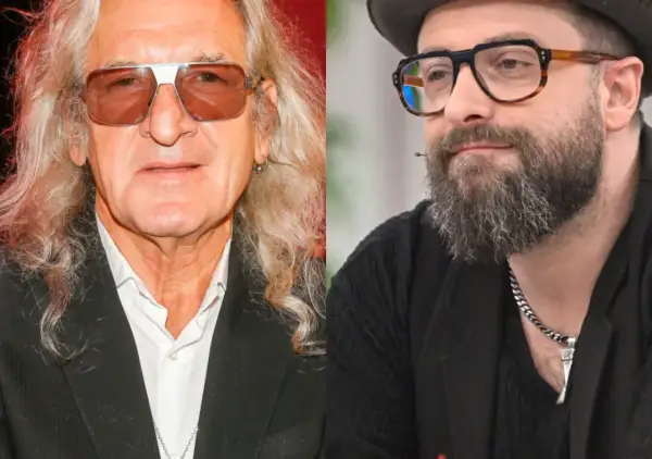 Dwaj artyści, jeden z długimi blond włosami i okularami przeciwsłonecznymi, drugi z brodą i okularami w stylu retro. Tworzą duet, który mógłby ułożyć perfect piosenki alfabetycznie.