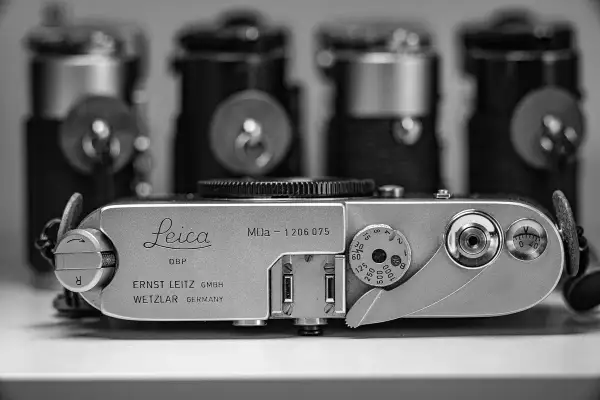 A vintage Leica MDa camera, a classic piece of photographic history, sits in the foreground.