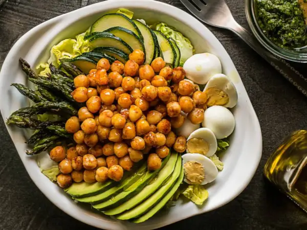 Ensalada de garbanzos con espárragos, aguacate, huevo duro y calabacín. Ingredientes frescos y saludables.