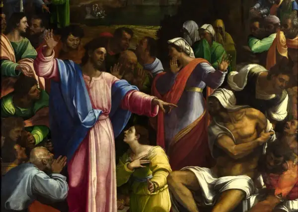 Jezus wskazuje na wskrzeszanego Łazarza. Tłum ludzi patrzy z podziwem i niedowierzaniem.